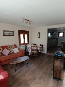 a living room with a couch and a table at La calma de Arnedillo in Arnedillo
