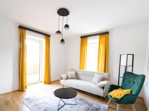 a living room with a couch and a chair at Murleben Top 06 in Stadl an der Mur