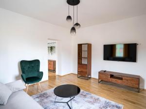 a living room with a couch and a tv and a chair at Murleben Top 06 in Stadl an der Mur