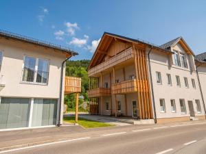 an apartment building with wooden balconies on a street at Murleben Top 06 in Stadl an der Mur
