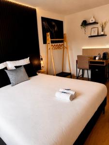 a bedroom with a bed with two towels on it at Charleroi Brussels Airport White Castle in Charleroi +86 photos