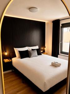 a bedroom with a large white bed with a large window at Charleroi Brussels Airport White Castle in Charleroi