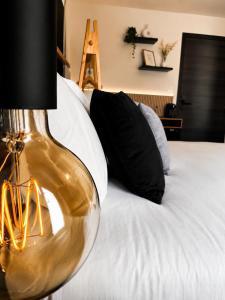 a close up of a bed with a lamp on it at Charleroi Brussels Airport White Castle in Charleroi
