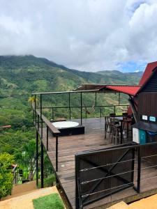 a deck with a hot tub and a table and chairs at AJ EcoGlamping in Santo Domingo