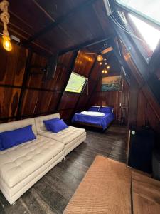 a living room with two beds and a couch at AJ EcoGlamping in Santo Domingo