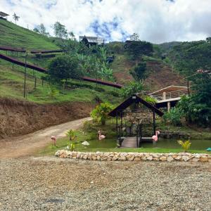 a garden with a gazebo on the side of a hill at AJ EcoGlamping in Santo Domingo
