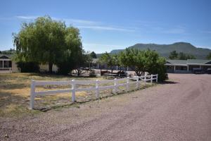 a white fence on the side of a dirt road at Alpine Adventures Inn in Alpine