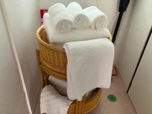 a stack of towels in baskets in a bathroom at あわら湯のまち駅から徒歩3分の湯の花ハウス in Awara +15 photos