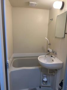 a bathroom with a sink and a bath tub at Guest House "Ro"Hieda B101 in Shimonoseki +14 photos