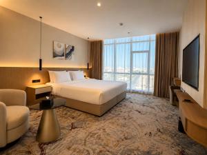 a hotel room with a bed and a television at فندق بيات سيتي in Taif