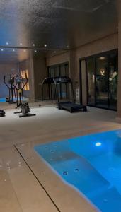 a gym with a swimming pool and some exercise equipment at Villa élite in Tangier +21 photos