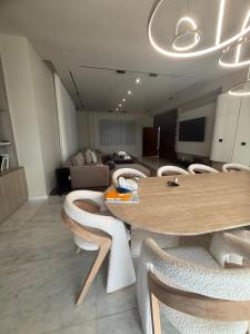 a room with a table and chairs and a couch at Villa élite in Tangier