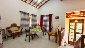 a living room with chairs and a table and a tablektop at Blissful Chateau in Batigama
