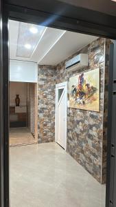 a room with a stone wall and a door at Appartement Agadir T2 pour couples maries et familles in Agadir