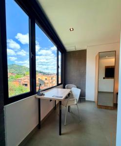 an office with a desk and a window with a view at Once Suites in Envigado