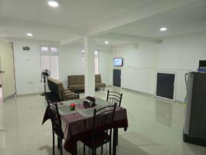 a living room with a table and a couch at Kandy City View Apartments in Kandy