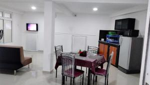 a dining room with a table and chairs at Kandy City View Apartments in Kandy +6 photos