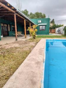 a swimming pool in front of a building at Refugio de Chacras in Ciudad Lujan de Cuyo