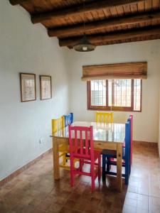 a dining room with a wooden table and chairs at Refugio de Chacras in Ciudad Lujan de Cuyo