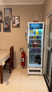 a refrigerator filled with lots of drinks in a room at Point Hotel in Tanabi