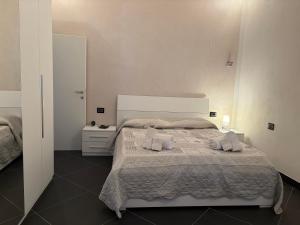 a bedroom with a bed with two towels on it at Casa Giulia in Taviano