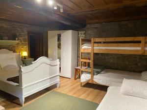 a bedroom with two bunk beds in a room at Quinta da Maínha - Charming Houses - com piscina privada in Braga +80 photos