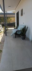 a porch with a bench on a patio at Cacique Room 2 in Playa Hermosa
