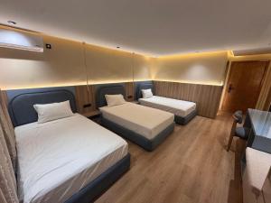 a small room with two beds and a desk at Appart Hotel Star in Tangier +58 photos