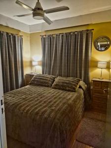 a bedroom with a bed and a ceiling fan at Villa Lainez in Villa Mercedes