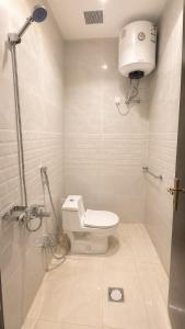 a small bathroom with a toilet and a shower at أرياف سويت in Al Baha