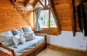 a couch sitting in a room with a window at Carreño Andino in San Carlos de Bariloche