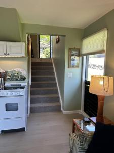 a living room with a stove and a staircase at Unit 05 Well Maintained Studio in Pahala