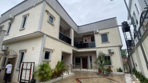 a man standing in front of a house at Zemira Apartments in Abuja