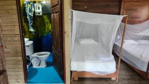 a small room with a bed and a toilet at Posada Don Aí in El Valle +50 photos