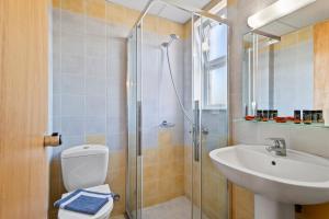 a bathroom with a toilet and a sink and a shower at Alonia Hotel Apartments in Kolymvari +76 photos