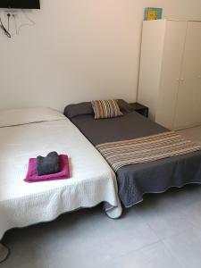 two beds sitting next to each other in a room at El Hostalito in Ontinyent