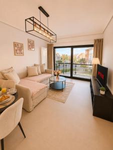 a living room with a couch and a table at Spacious Apartment 1BR with Sofa bed near Atomium, Expo 12 and ING Arena in Wemmel