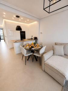 a kitchen and living room with a table and a couch at Spacious Apartment 1BR with Sofa bed near Atomium, Expo 12 and ING Arena in Wemmel +12 photos