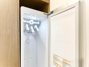 ajar door of a refrigerator with a teddy bear on it at 군산 비욘드 호텔 in Sinp'ung +93 photos