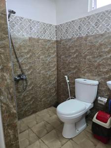 a bathroom with a toilet and a shower at Kandy City View Apartments in Kandy