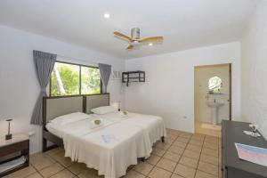 a bedroom with a bed and a ceiling fan at easy diving and beach resort in Manlocahoc