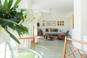 a living room with a glass table and a couch at Romantic Pier by Rent All Como in Carate Urio