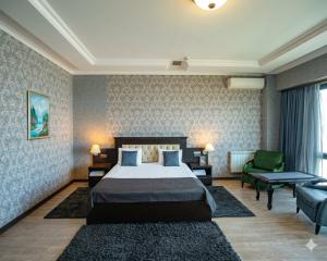 a hotel room with a bed and a couch at Caspian Seaside Hotel in Sumqayıt +29 photos