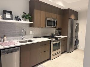 a kitchen with a sink and a refrigerator at Winchelsea Views in Nanaimo
