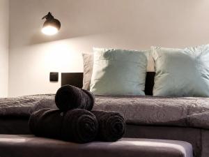 a pile of towels sitting on a bed at The Jade Elegant apartment with balcony in Spa