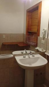 a bathroom with a sink and a toilet at Hosteria Lekun Lekun in Villa La Angostura +55 photos