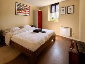 a bedroom with a large bed and a television at Chic vintage apartment in Spa in Spa