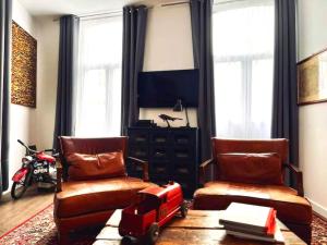 a living room with two chairs and a table at Chic vintage apartment in Spa in Spa