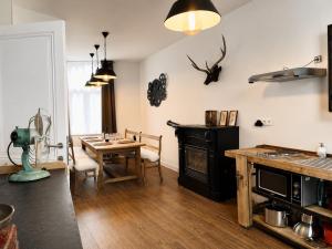 a kitchen with a table and a dining room at Chic vintage apartment in Spa in Spa