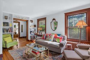 a living room with a couch and a table at Classic Stockbridge Cottage in Stockbridge